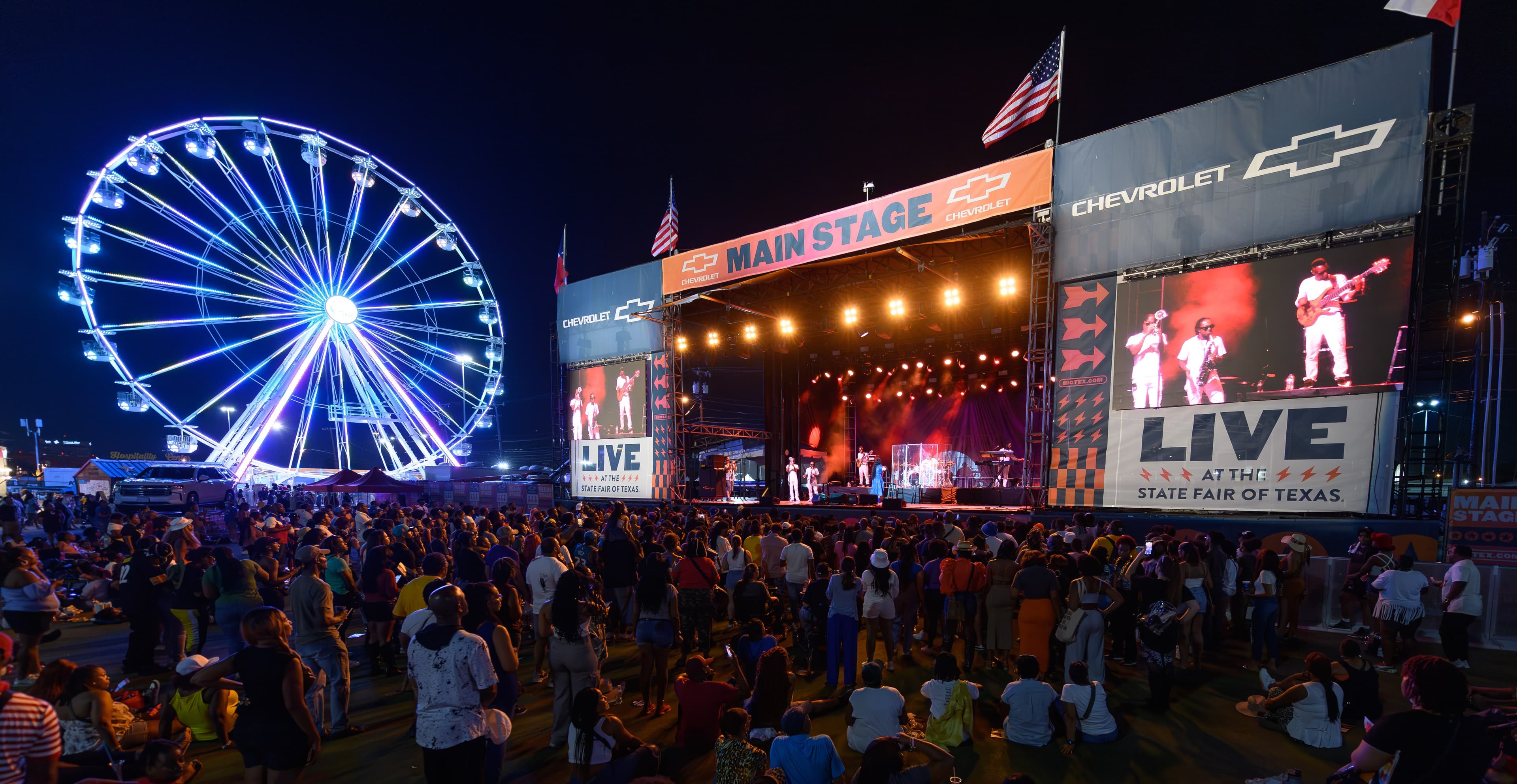 File photo: The former outdoor Chevrolet Main Stage and a Ferris wheel are illuminated during a 2023 concert. The new 2026 Old Mill stage is not shown.